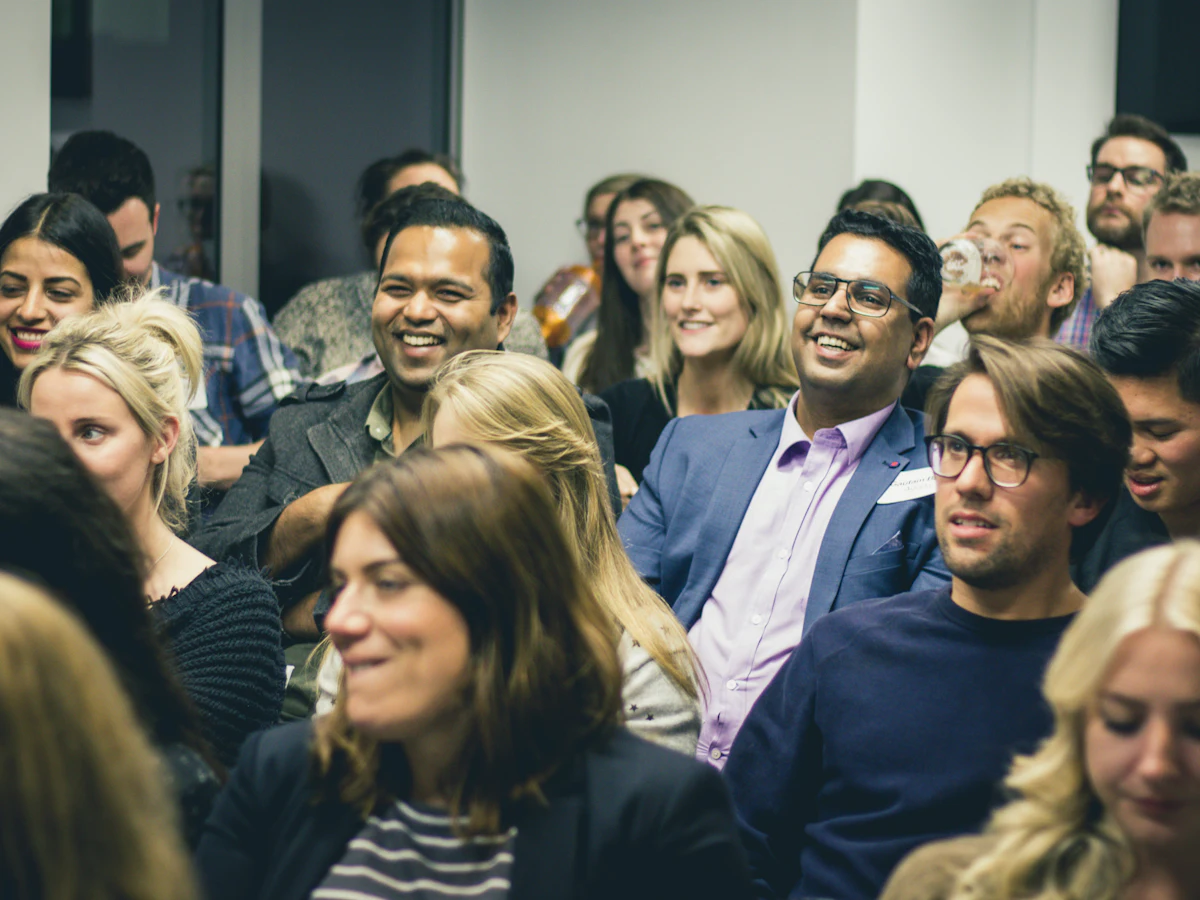 Participants listen and smile during a workshop
